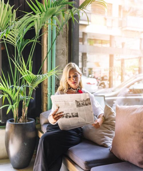 portrait-beautiful-young-woman-sitting-caf-reading-newspaper